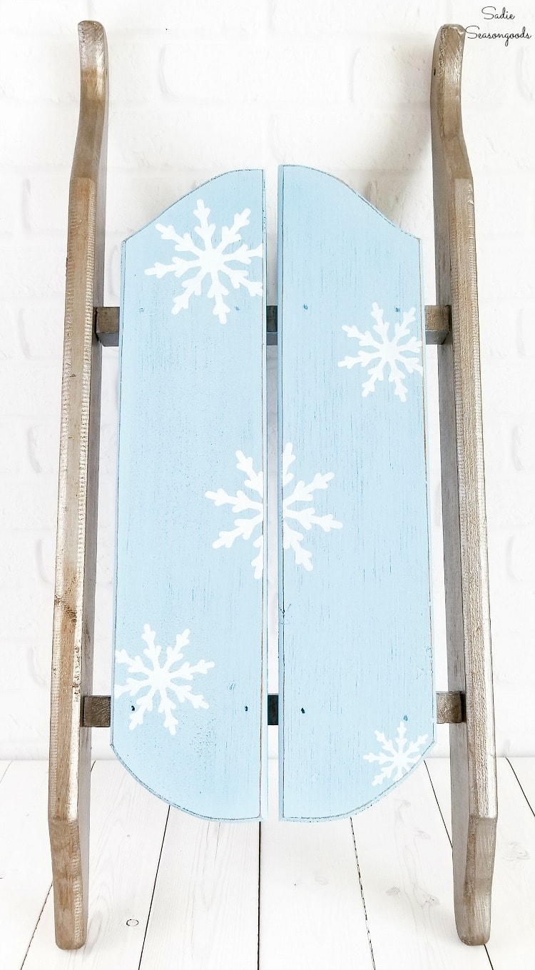 Using a winter stencil on a decorative sled