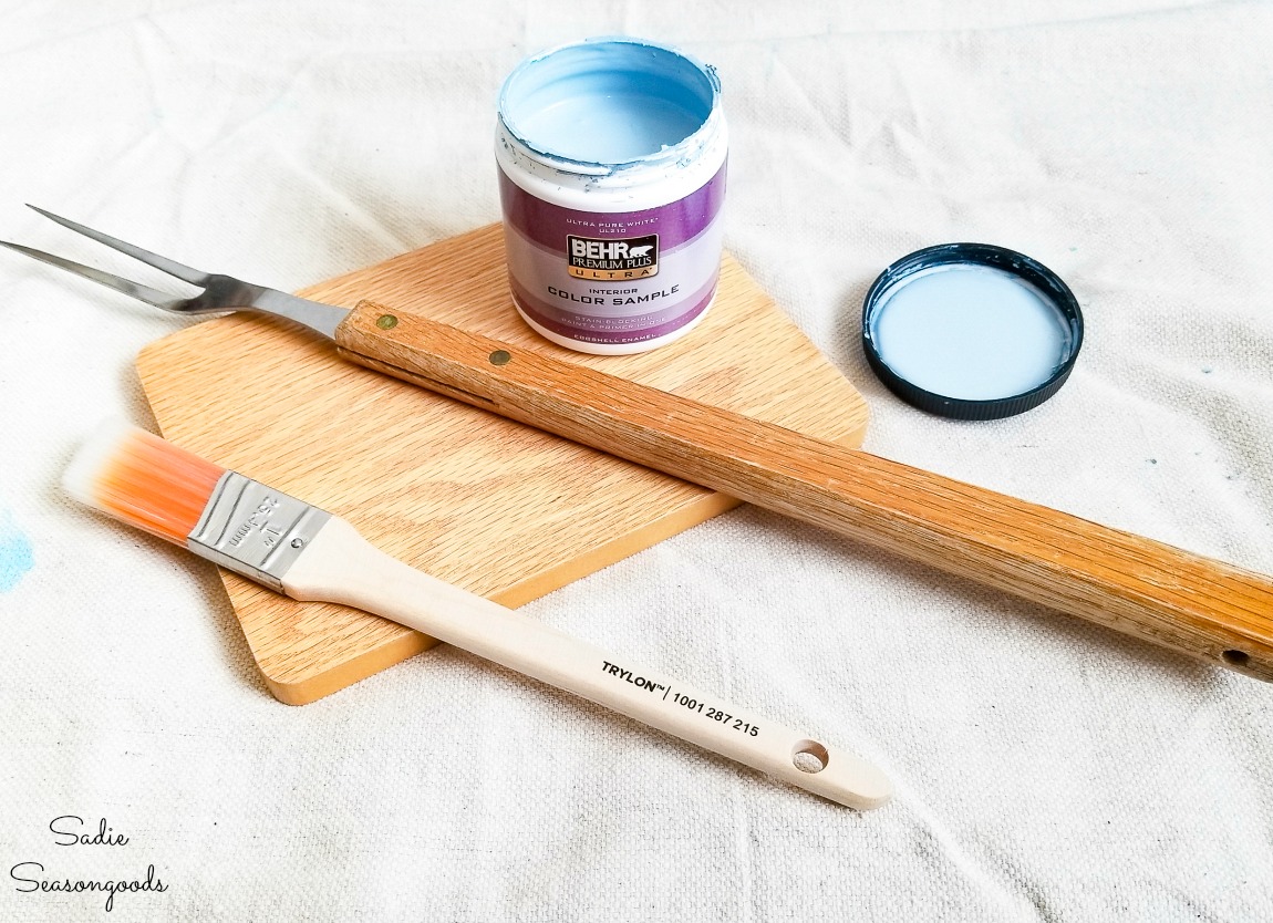 Painting a barbecue fork to use as decorative garden stakes