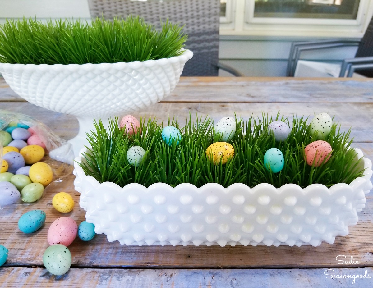 Speckled eggs on a plastic grass mat as Easter decoration ideas in milk glass dishes