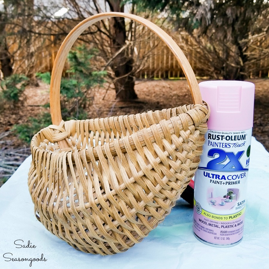 Spray painting a flat back basket for upcycling into an Easter Wreath DIY