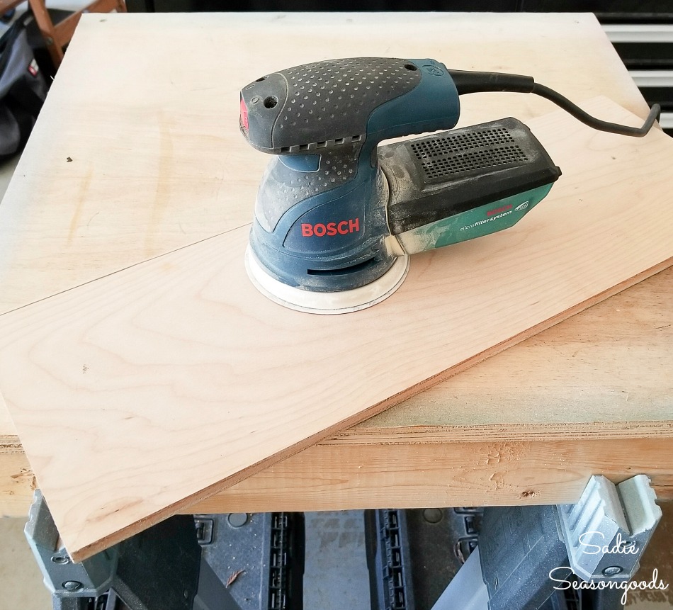 Bosch orbital sander on the plywood before applying the Weatherwood stains