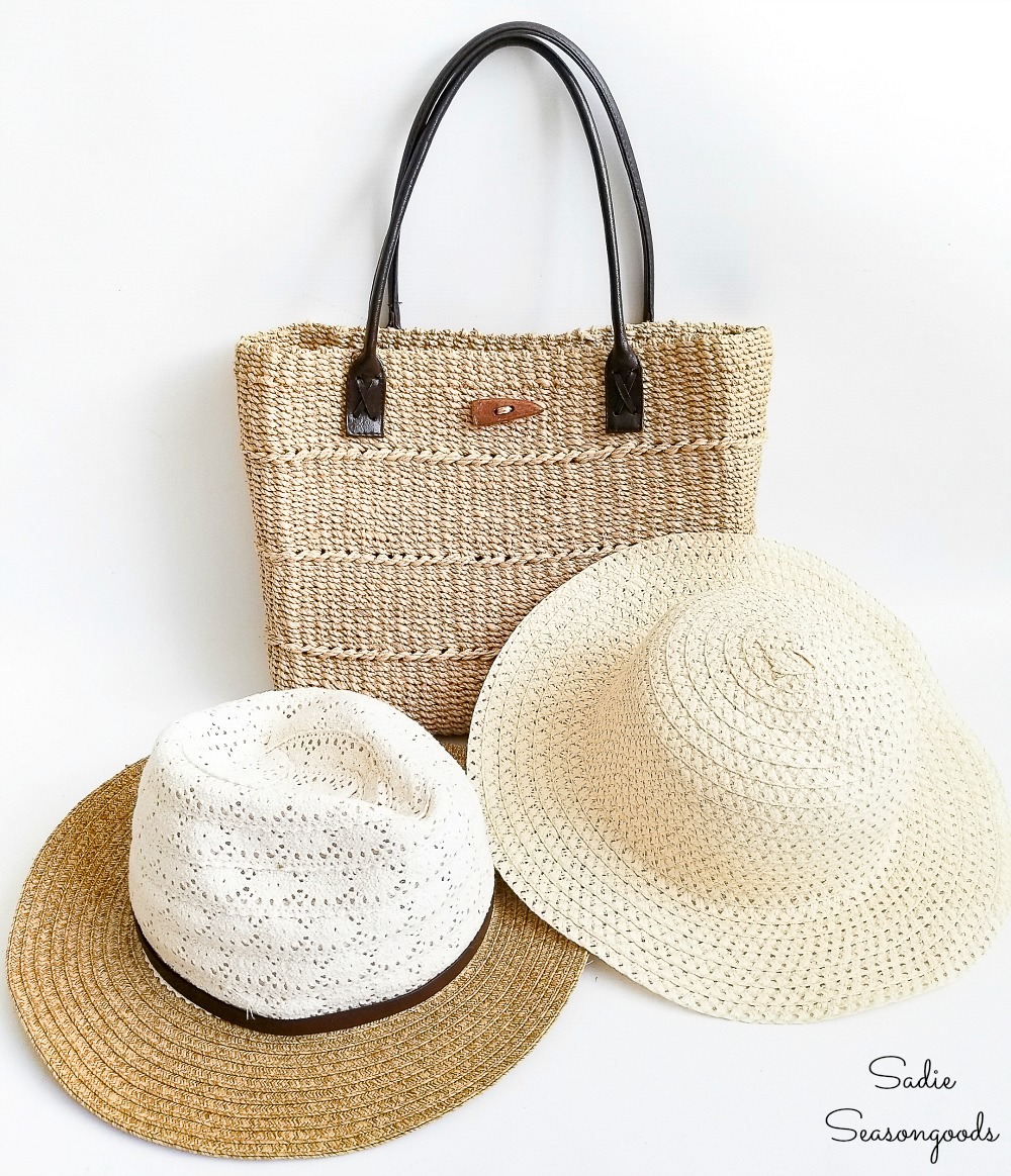 Thrift store accessories such as a woven tote bag and straw hats