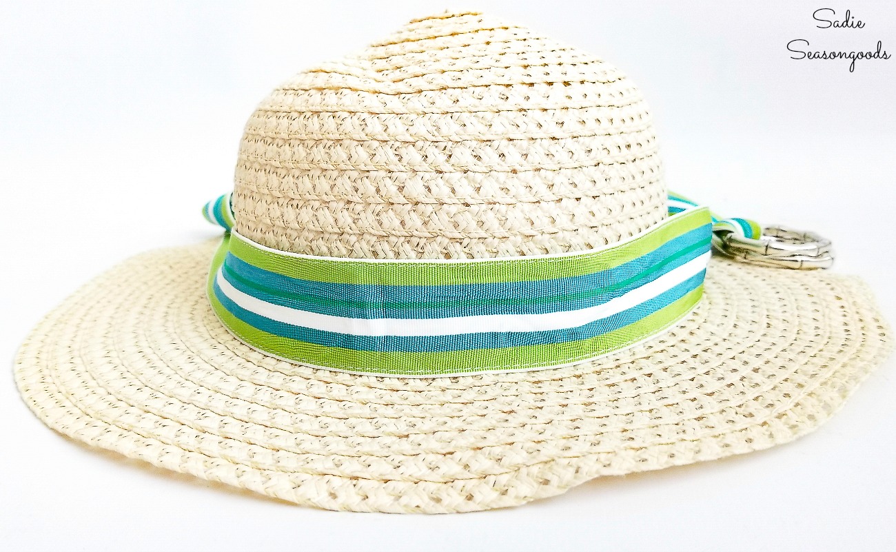 Using a ribbon belt to make a hat band on a sun hat from the thrift shop