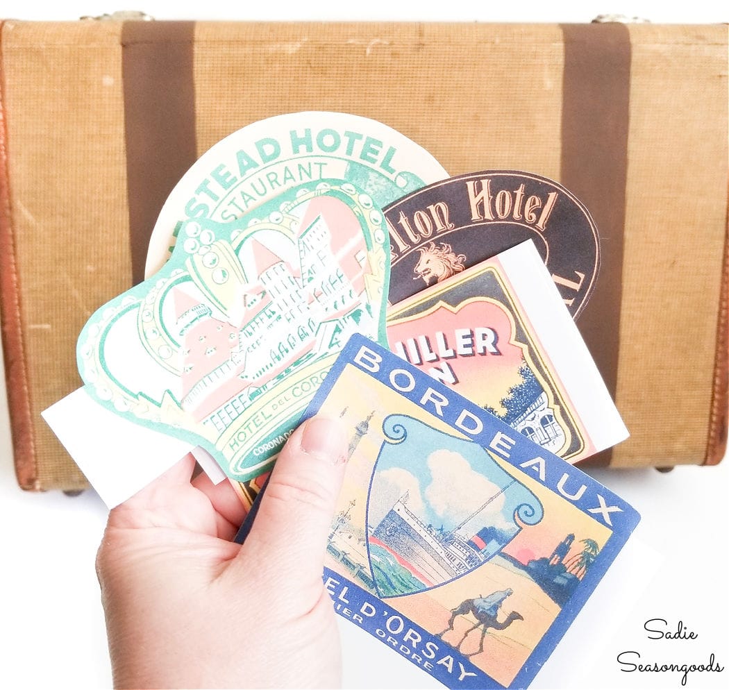 putting the travel stickers on vintage luggage decor