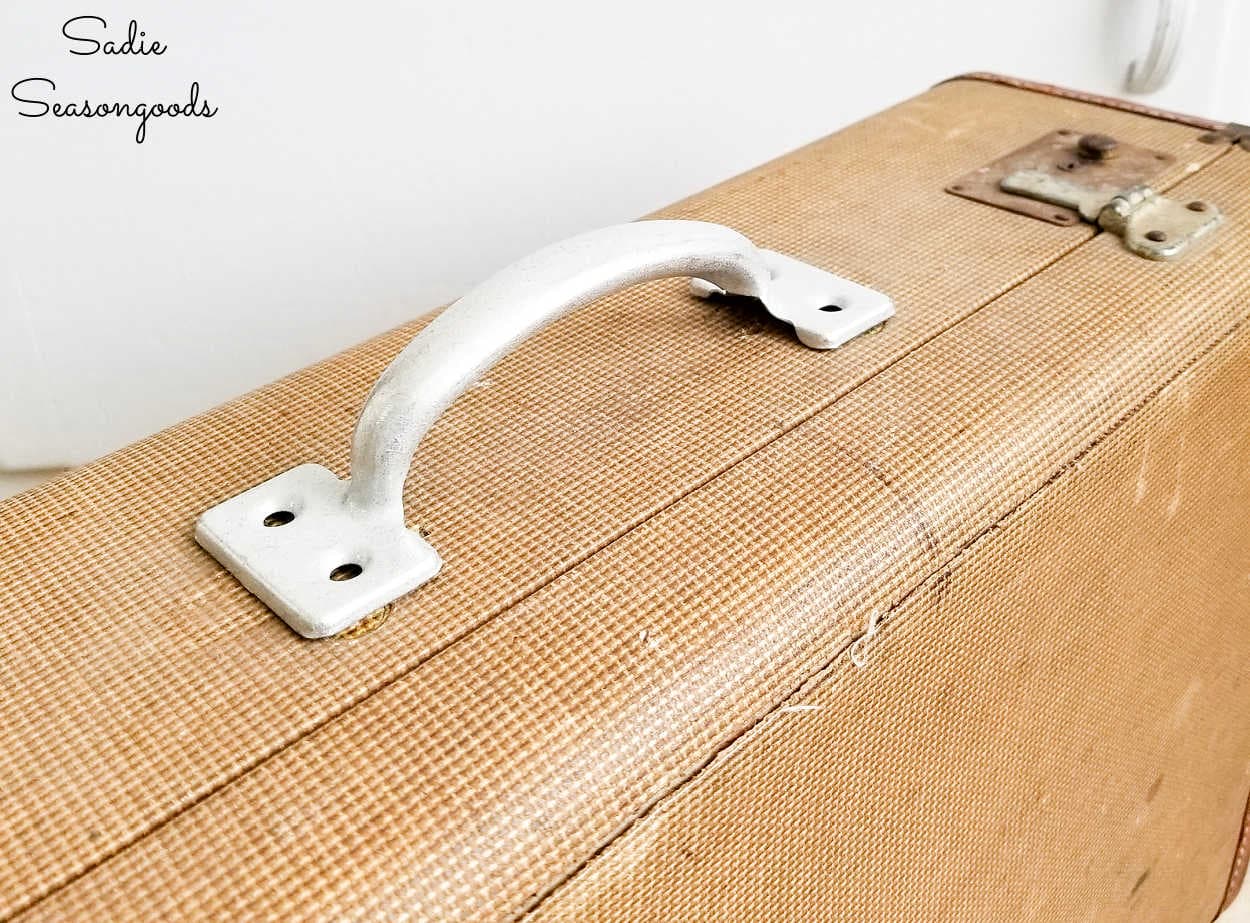repairing an old suitcase to use as vintage decor