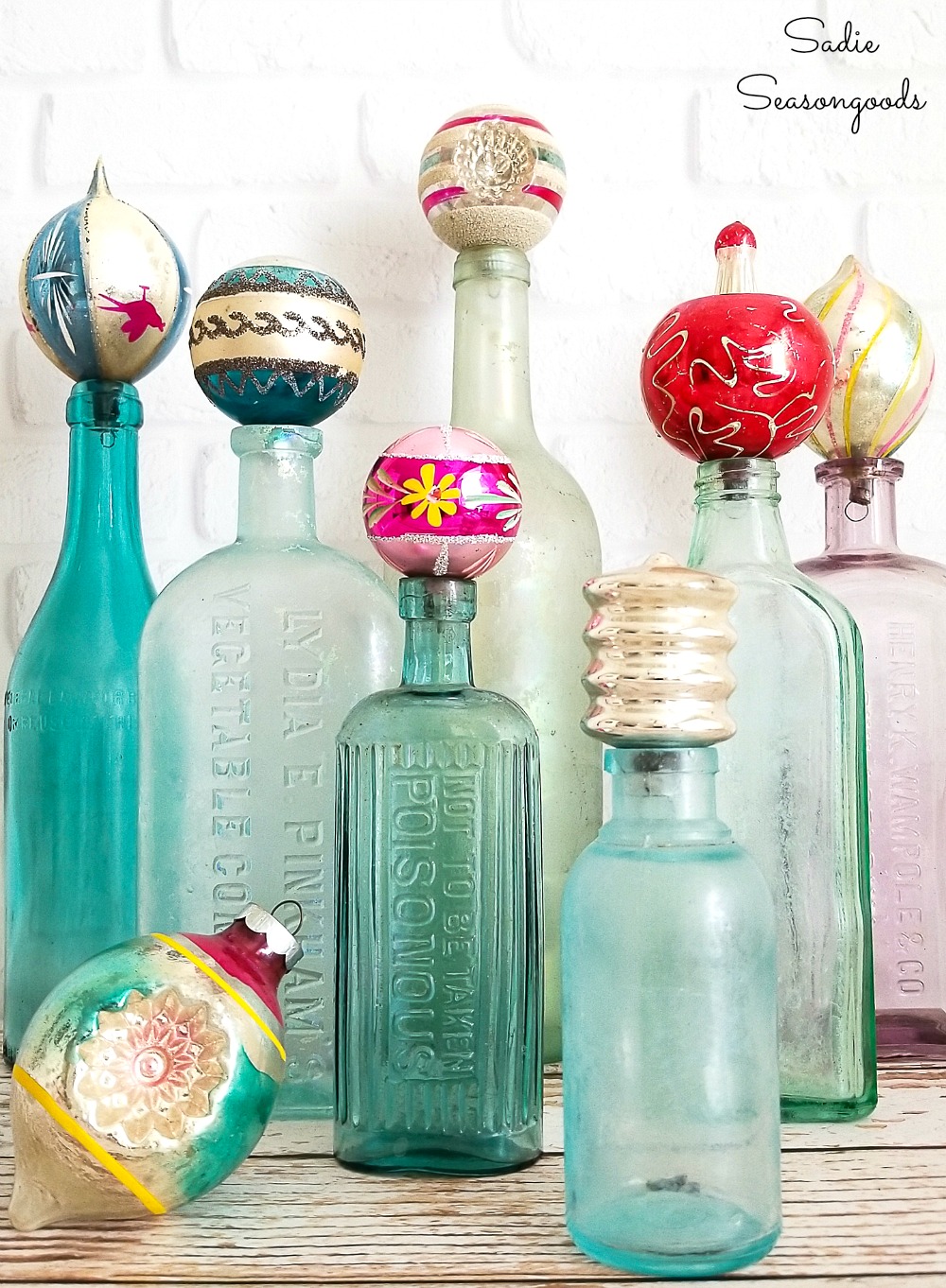 Retro Christmas Decorations with vintage Christmas ornaments on antique bottles