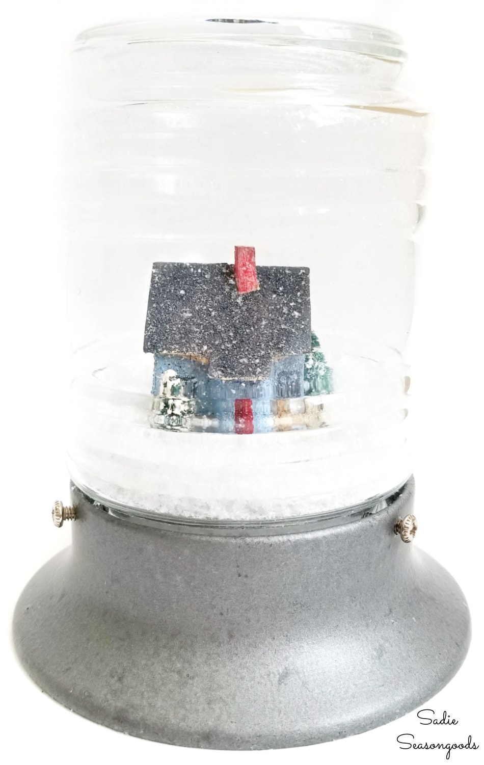 Winter snow globe with a vintage putz house