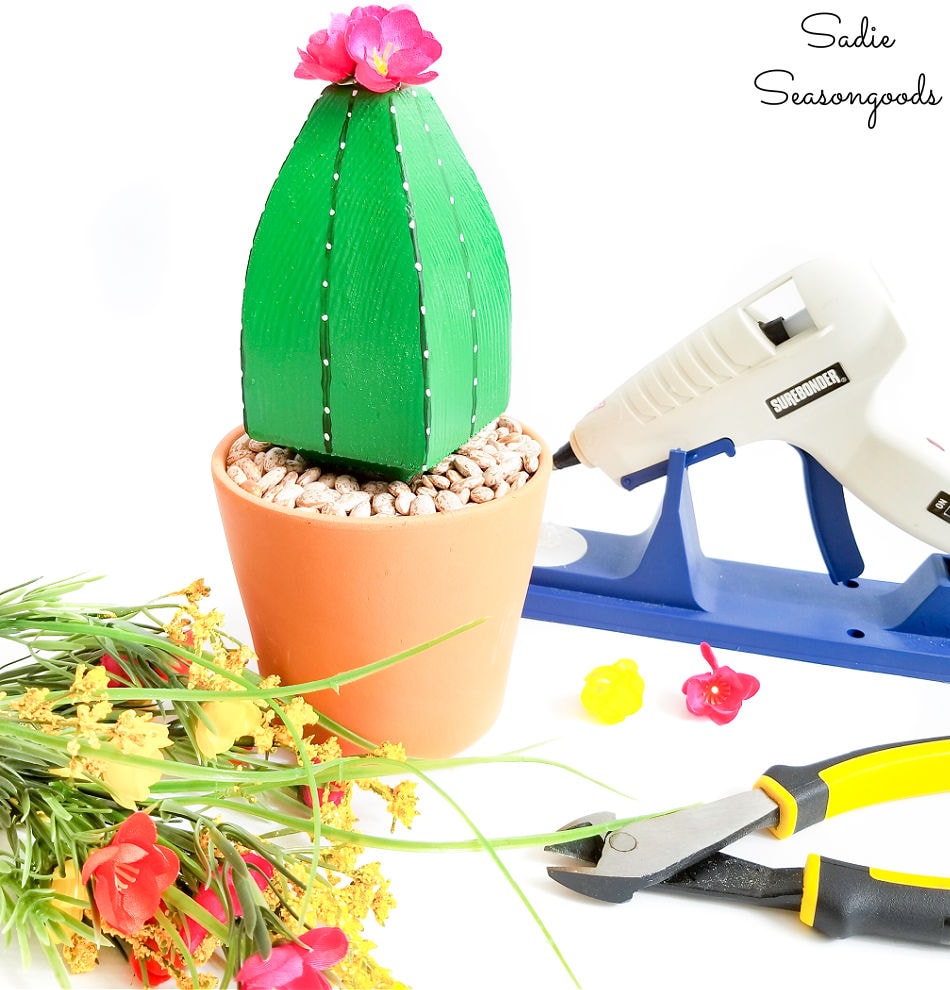 attaching the fake cactus flowers with hot glue