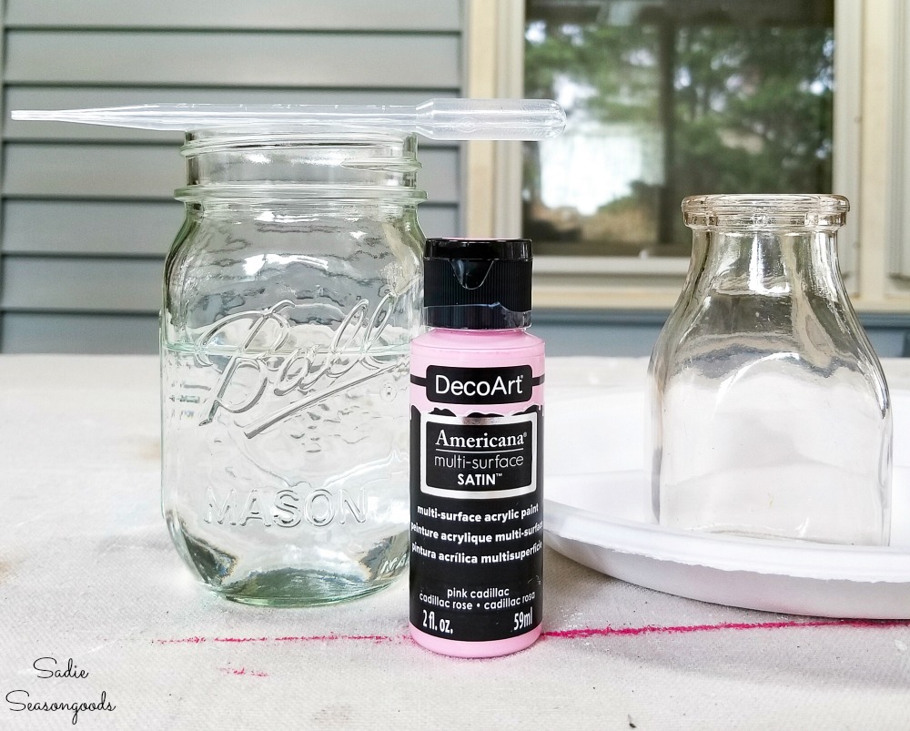 Thinning out craft paint with water before painting the inside of old glass milk bottles