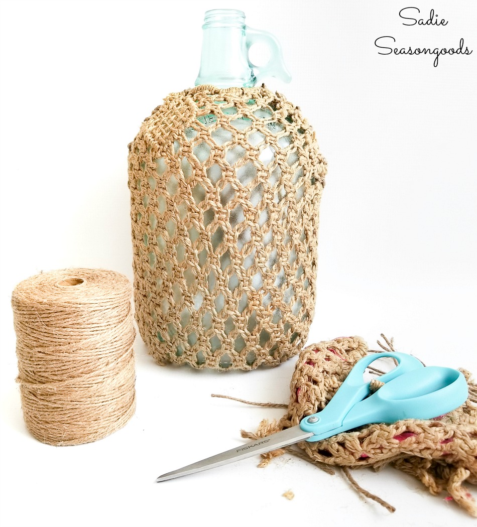 Fishing net decor on colored glass bottles for beach themed decor