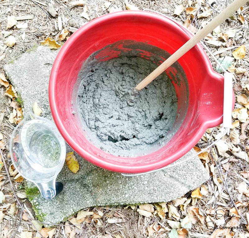 Mixing the cement to make the decorative garden stones in the copper molds