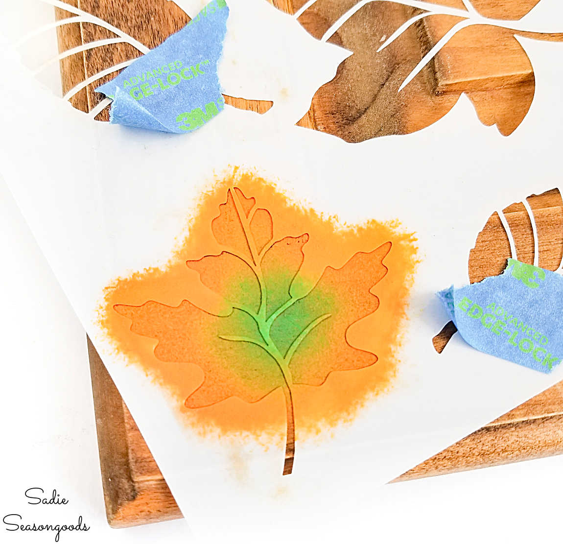 painting fall leaves on an autumn sign