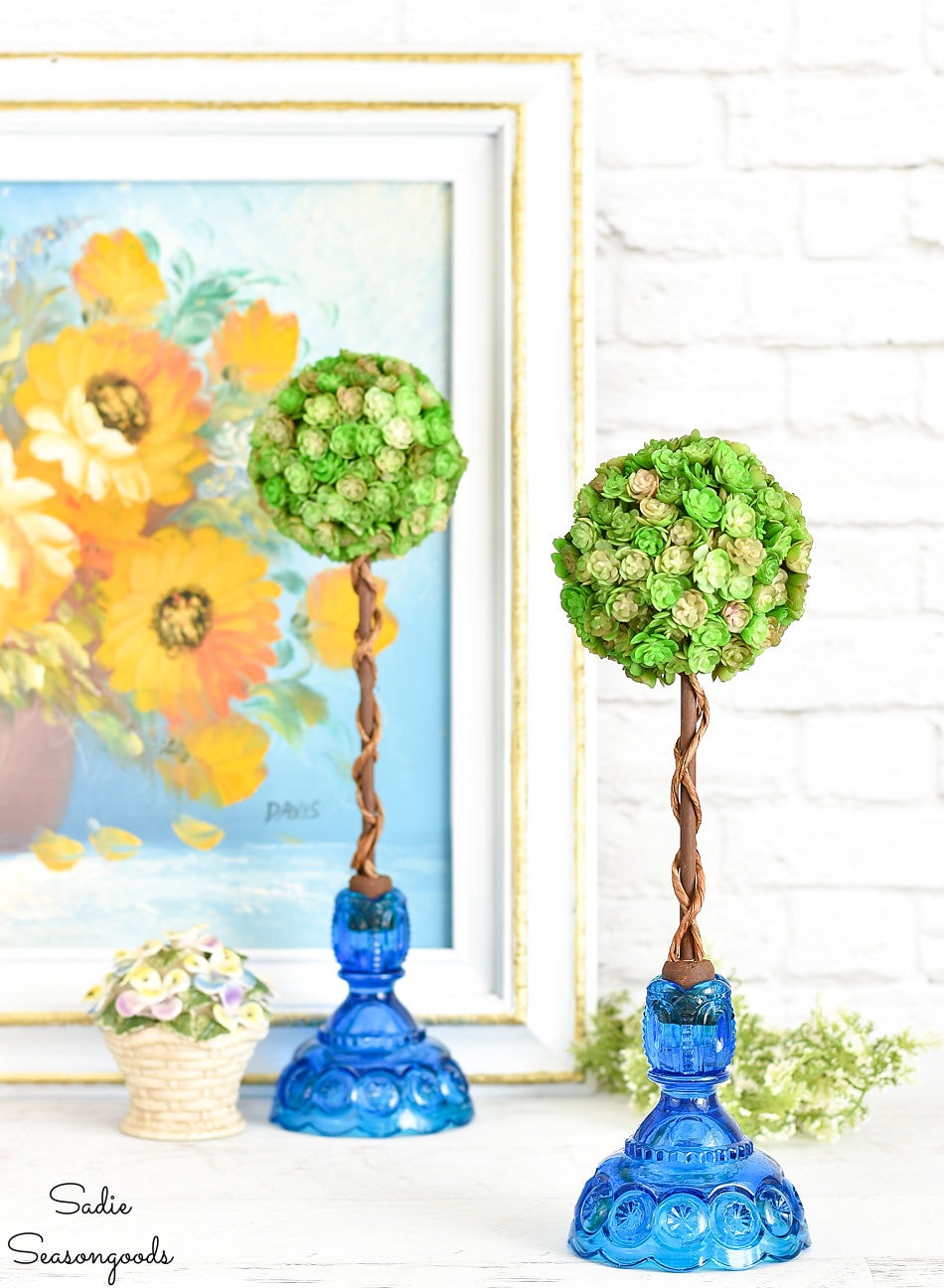 spring topiary in blue glass candle holders