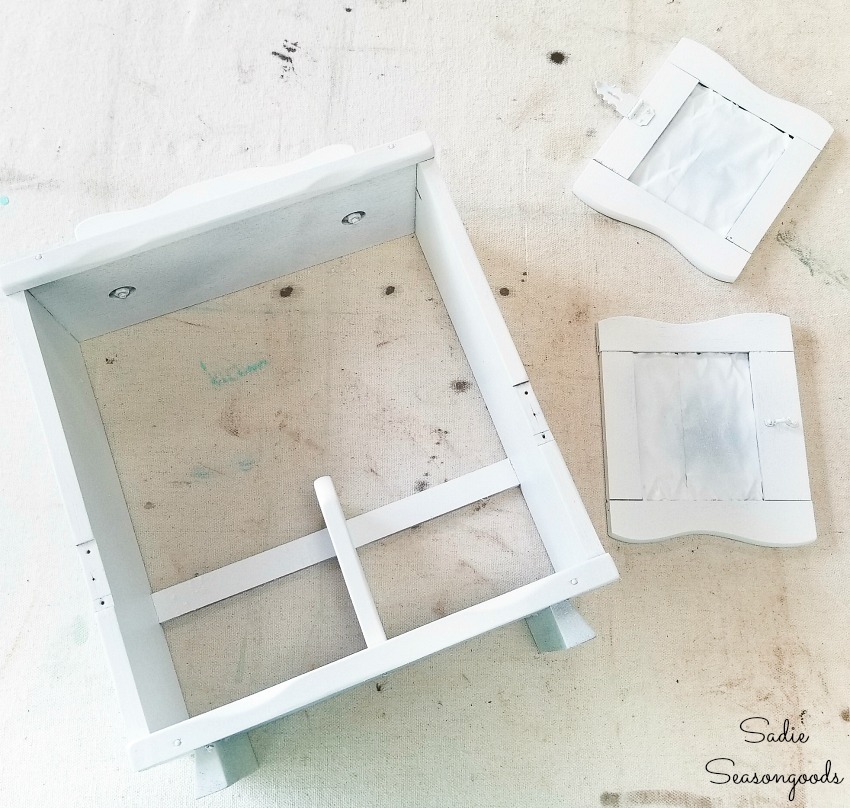 White spray paint on a wooden caddy for upcycling ideas