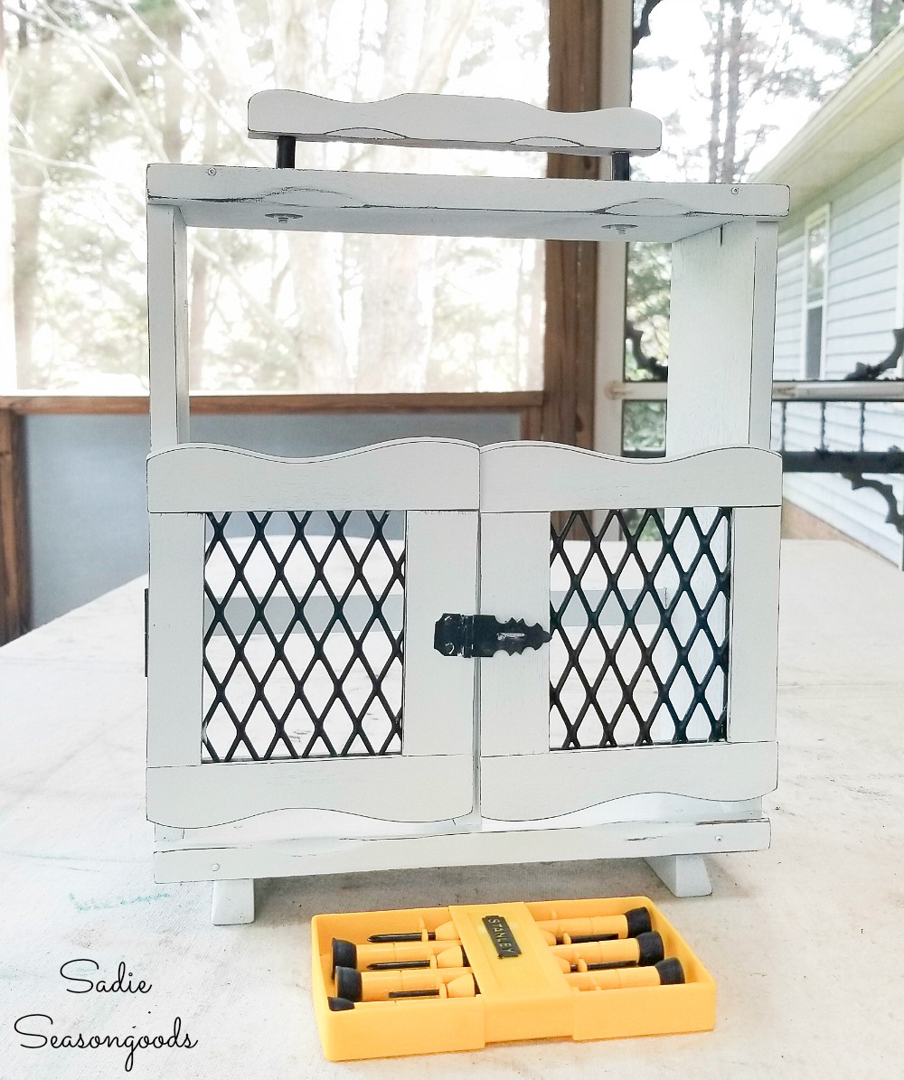 Wooden caddy for liquor decanters to become a holder for cut herbs