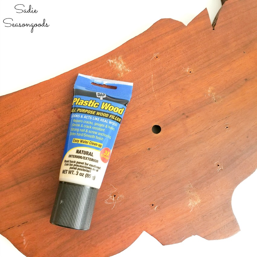 Wood filler or wood putty to fill in the holes before sanding