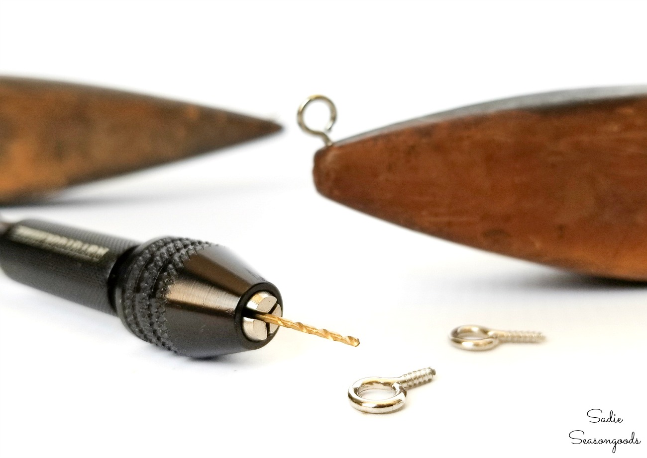 Tiny eye screws in the corners of a weaving shuttle