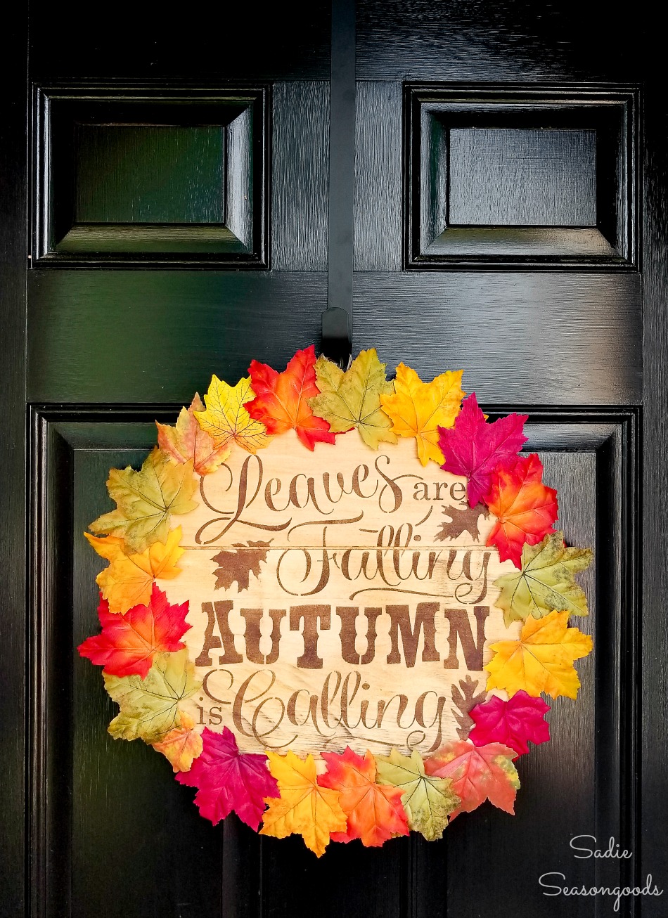 Lid of a wood cheese box as a fall door wreath