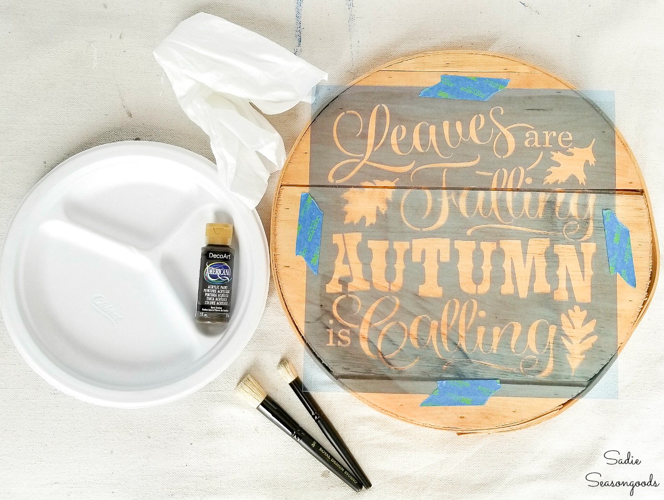 Stenciling with brown paint to look like a wood burned sign