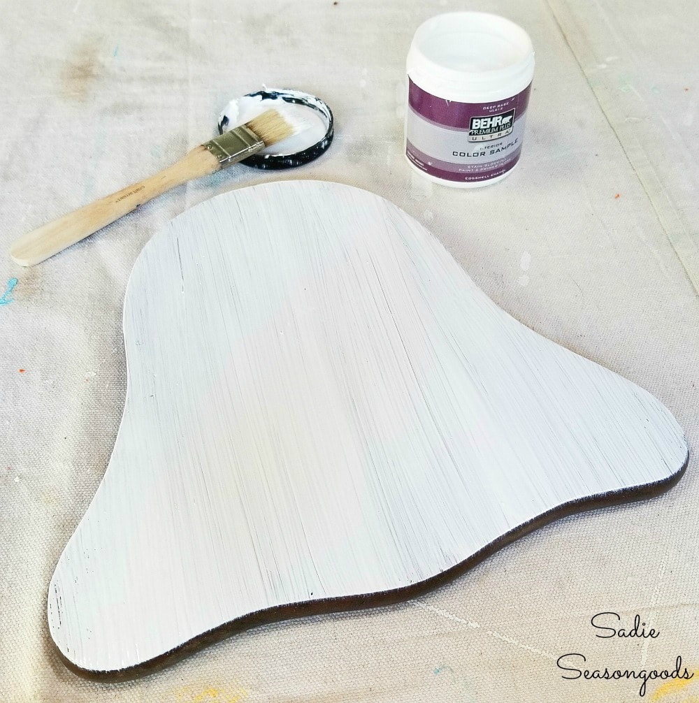 Painting a wooden cheese board to look like a DIY ghost