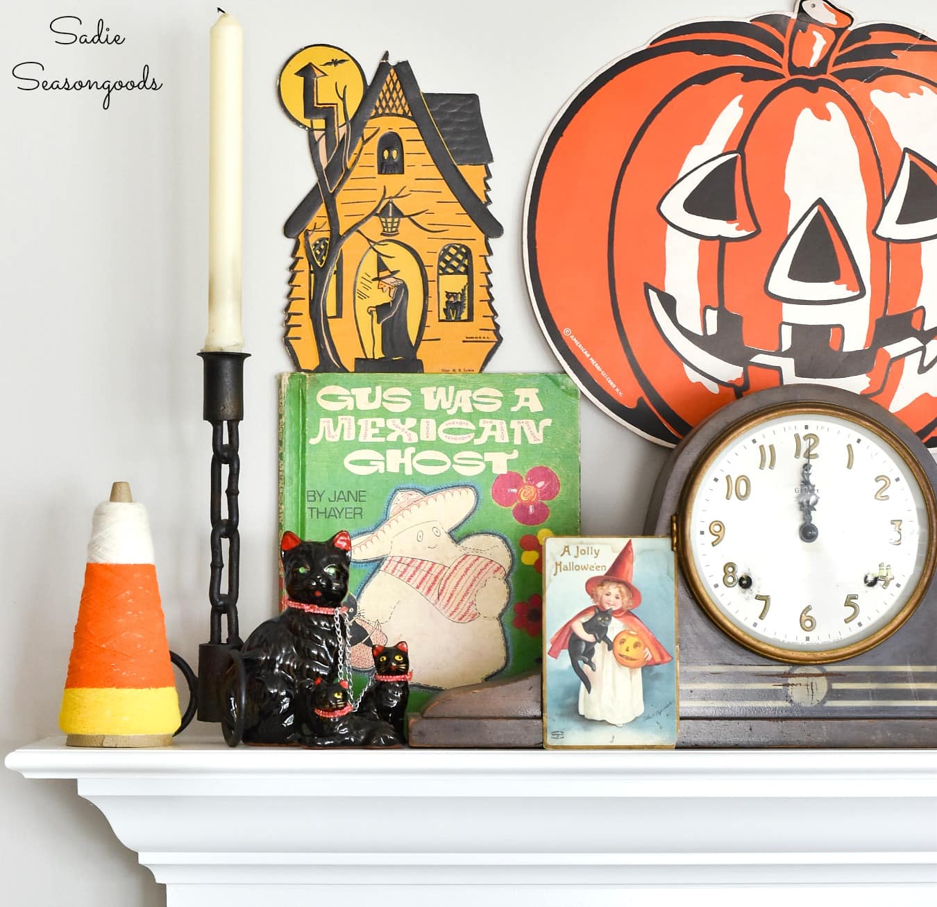 Vintage Halloween post cards and door hangers as mantel decor