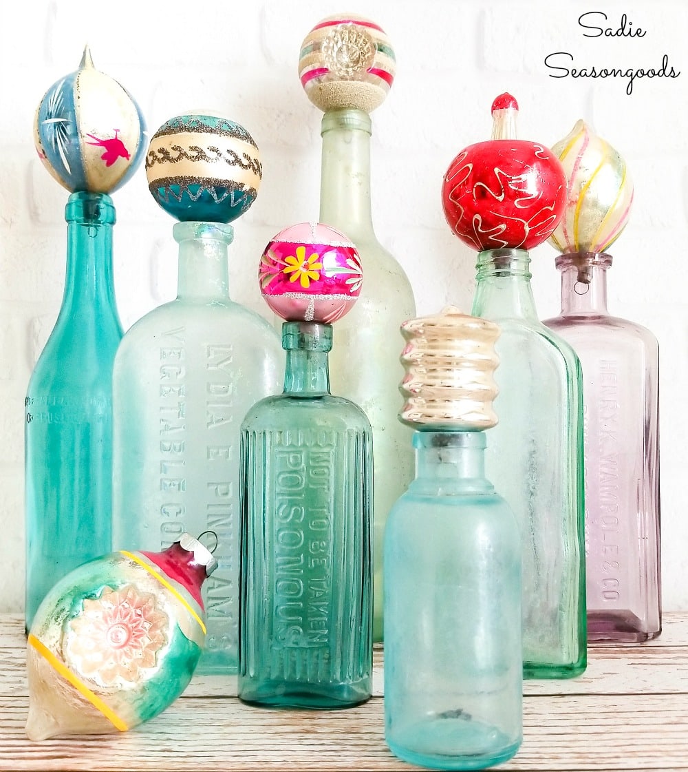 Thrifty Christmas decor with vintage ornaments as bottle toppers