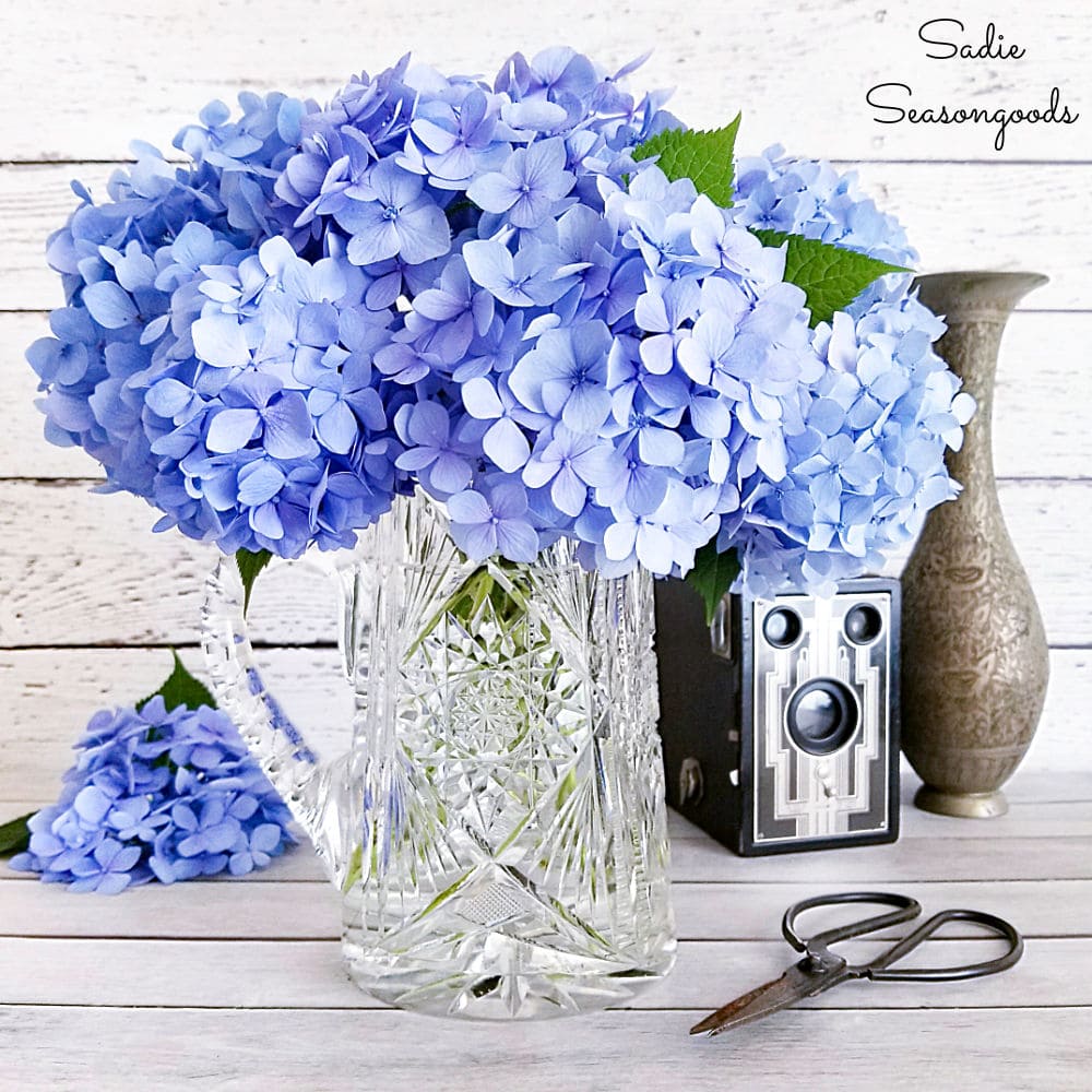 Antique crystal pitcher with blue hydrangeas