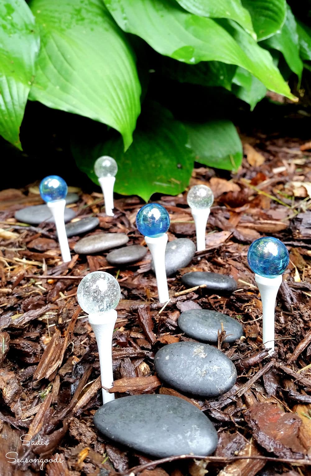 Golf tees as light poles in a DIY fairy garden