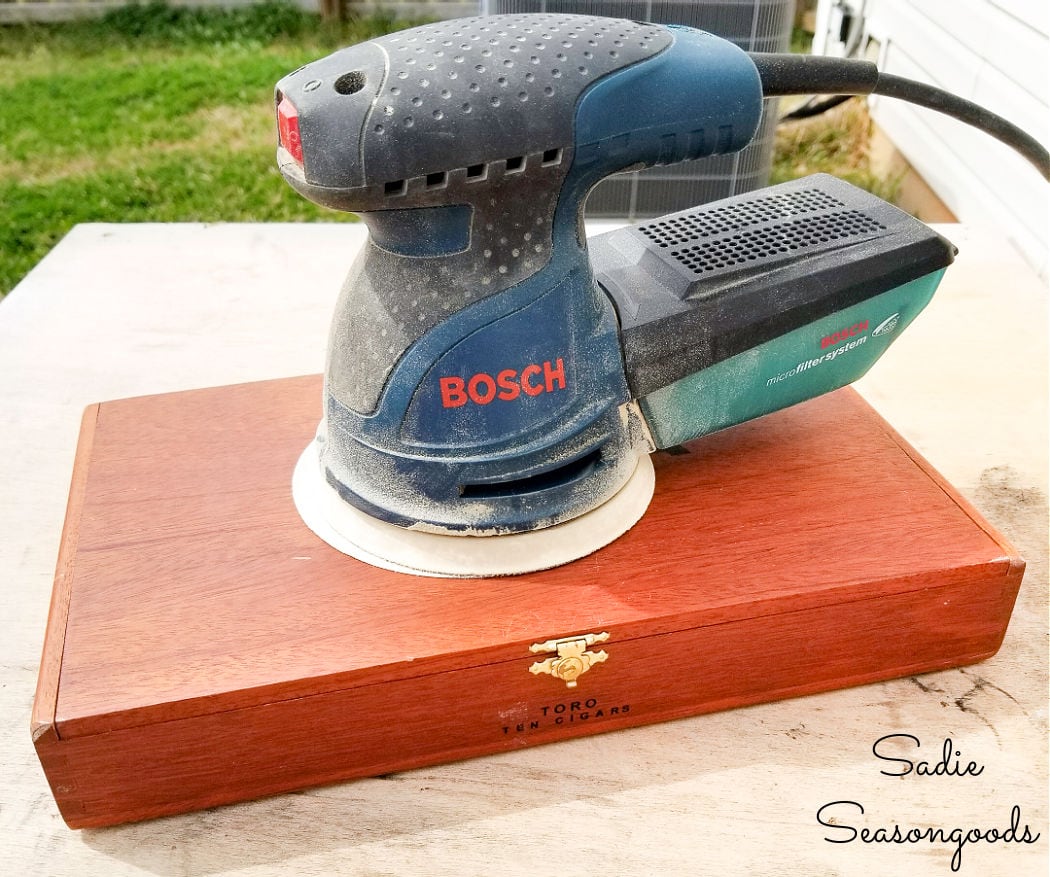 sanding the wooden cigar boxes