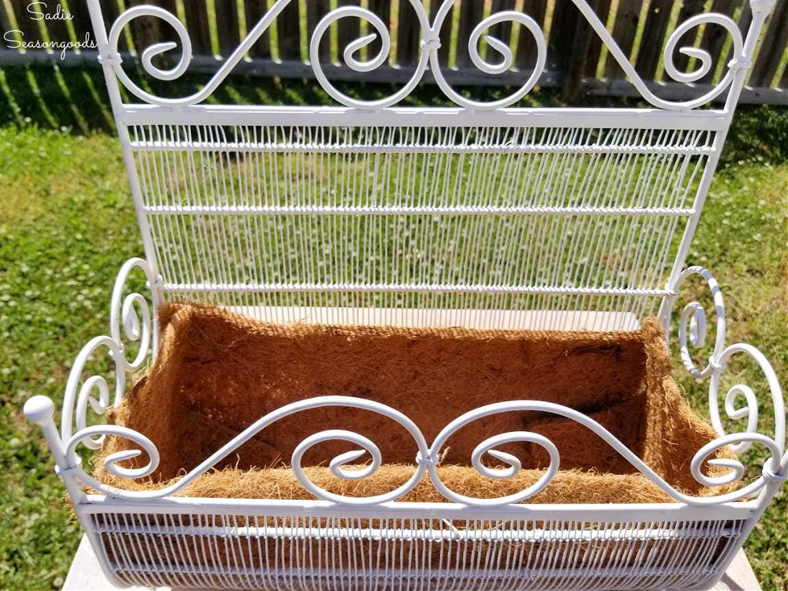 repurposing a floor magazine rack to hold plants