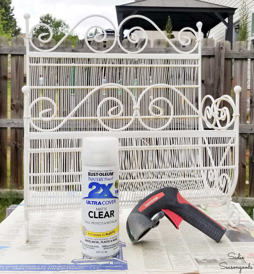 spraying a clear top coat on a repurposed planter