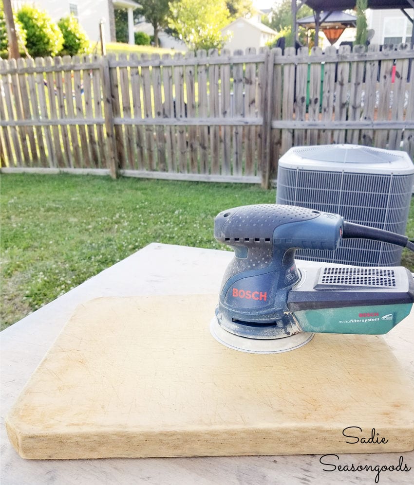 sanding an old cutting board