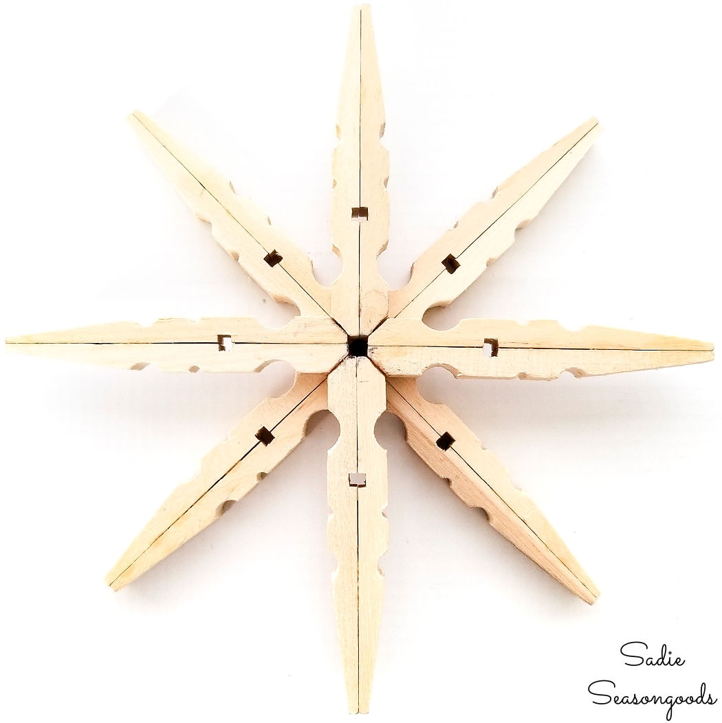 large wooden snowflake from clothespins