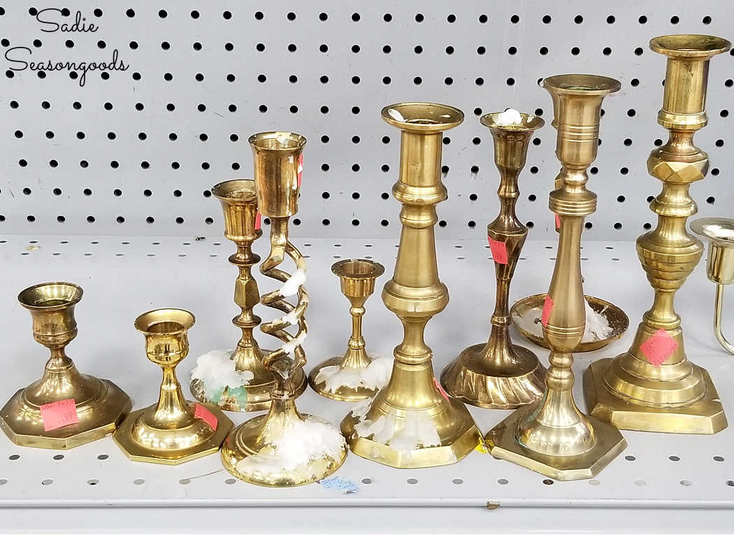 mismatched brass candlesticks at a thrift store