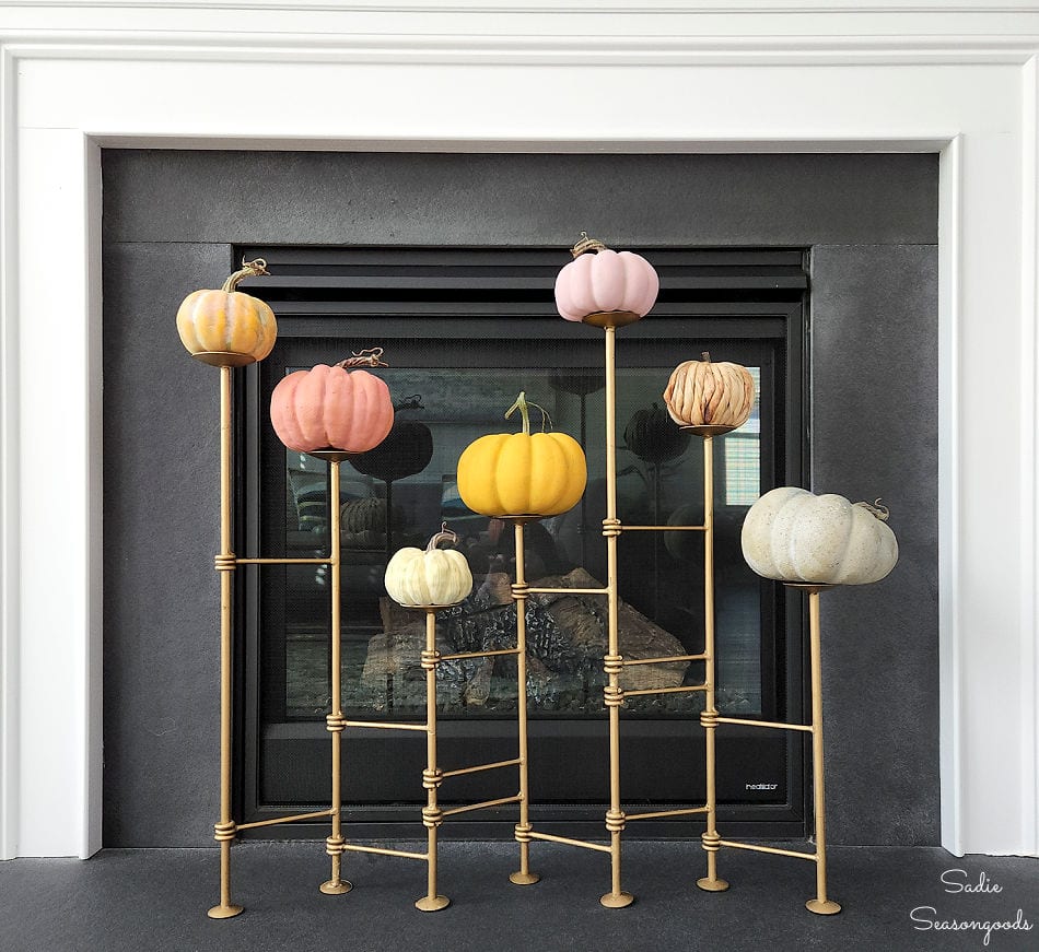 placing heirloom pumpkins on a candle holder screen for modern fall decor