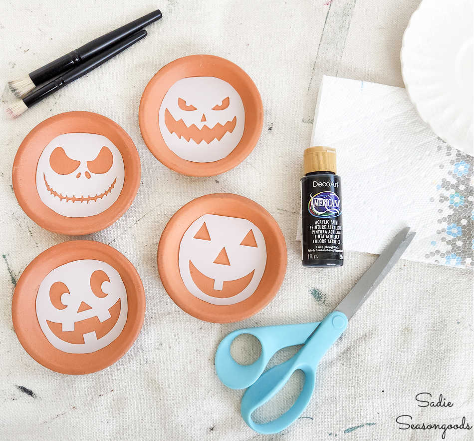 making jack o lantern coasters with a stencil and plant saucers