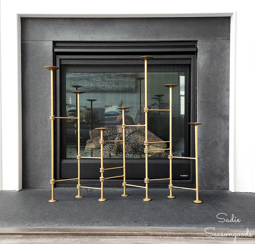 getting the look of modern fall decor for the fireplace with a folding candle holder