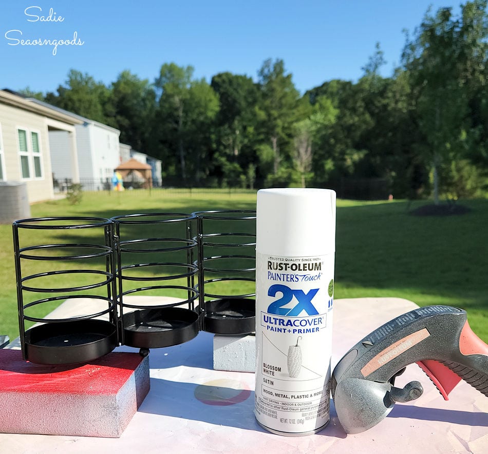 spray painting a metal utensil holder as part of a rainbow organizer