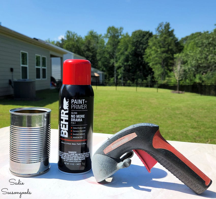 painting tin cans with spray paint in rainbow colors