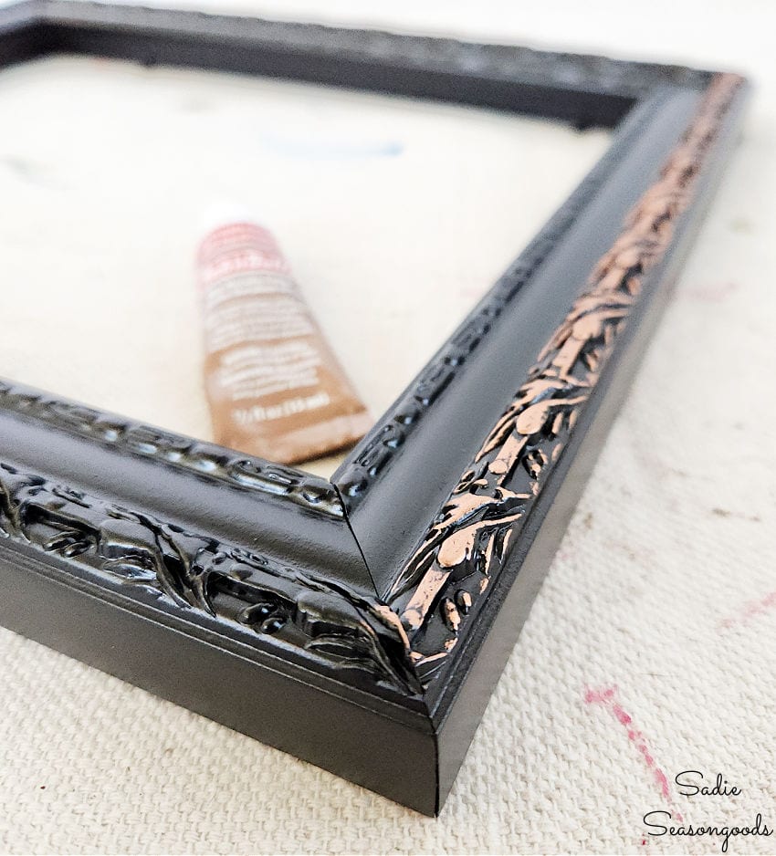 accenting the details on a picture frame with metallic wax