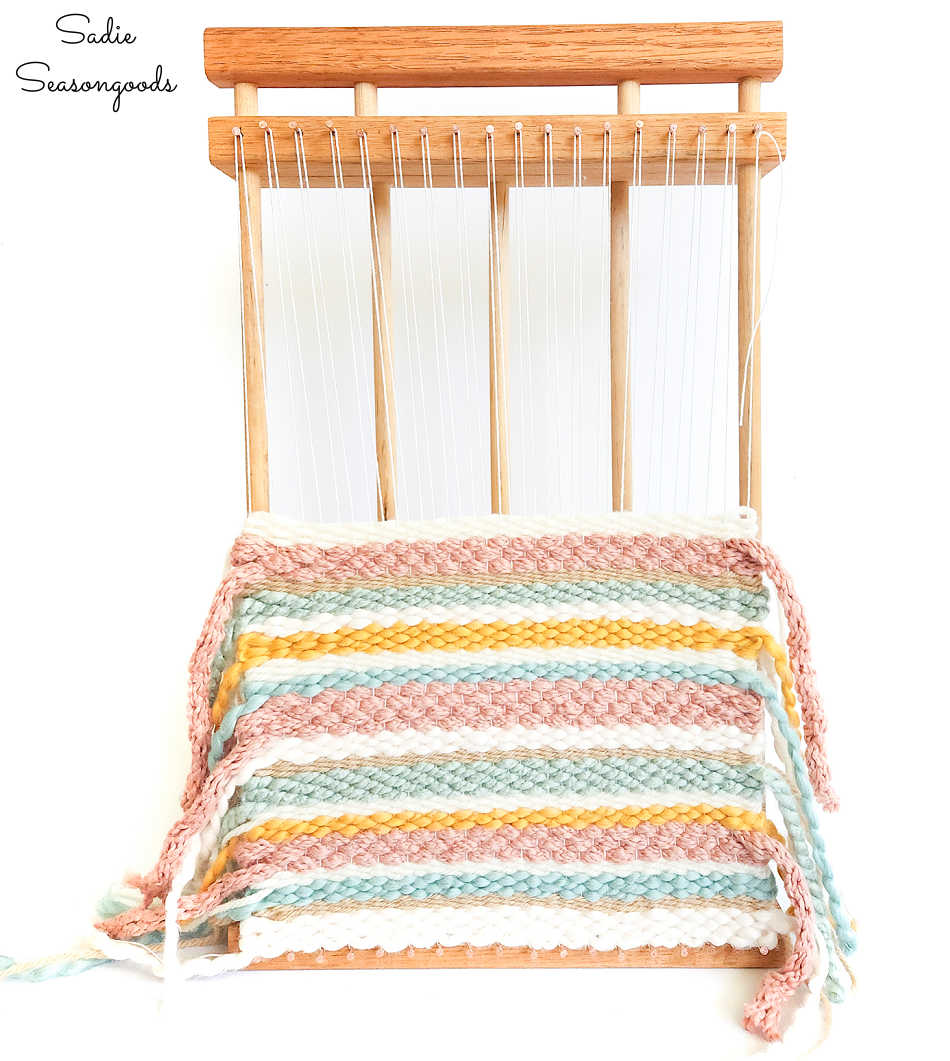 weaving on a diy loom in boho colors for fall decor