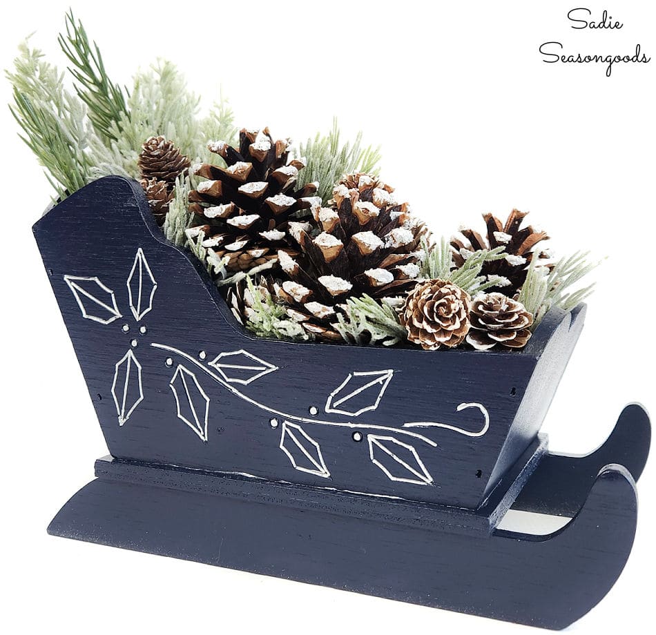 january decorations with winter greenery and a wooden sleigh