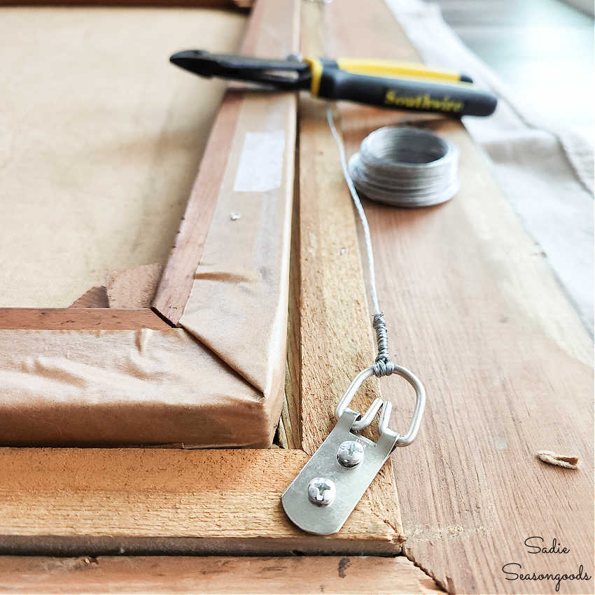 attaching d ring hangers and wire to the back of a frame