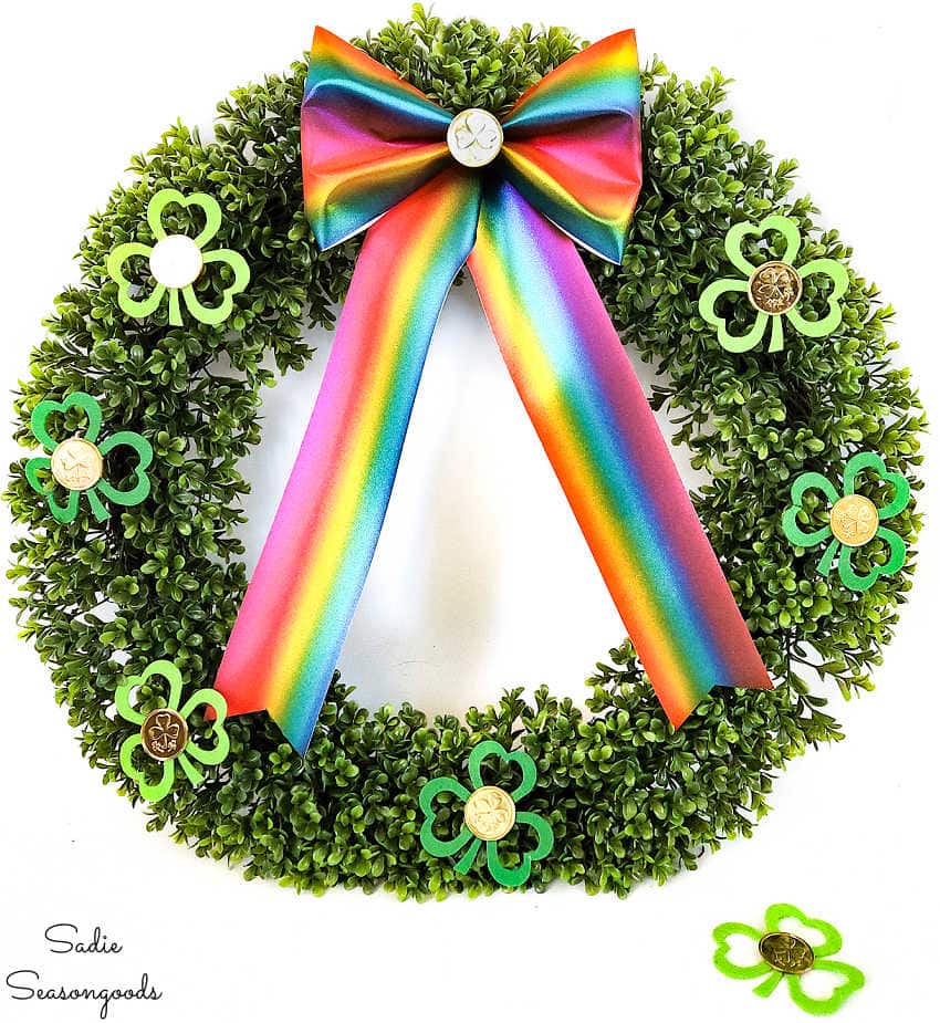 decorating a faux boxwood wreath with a shamrock garland