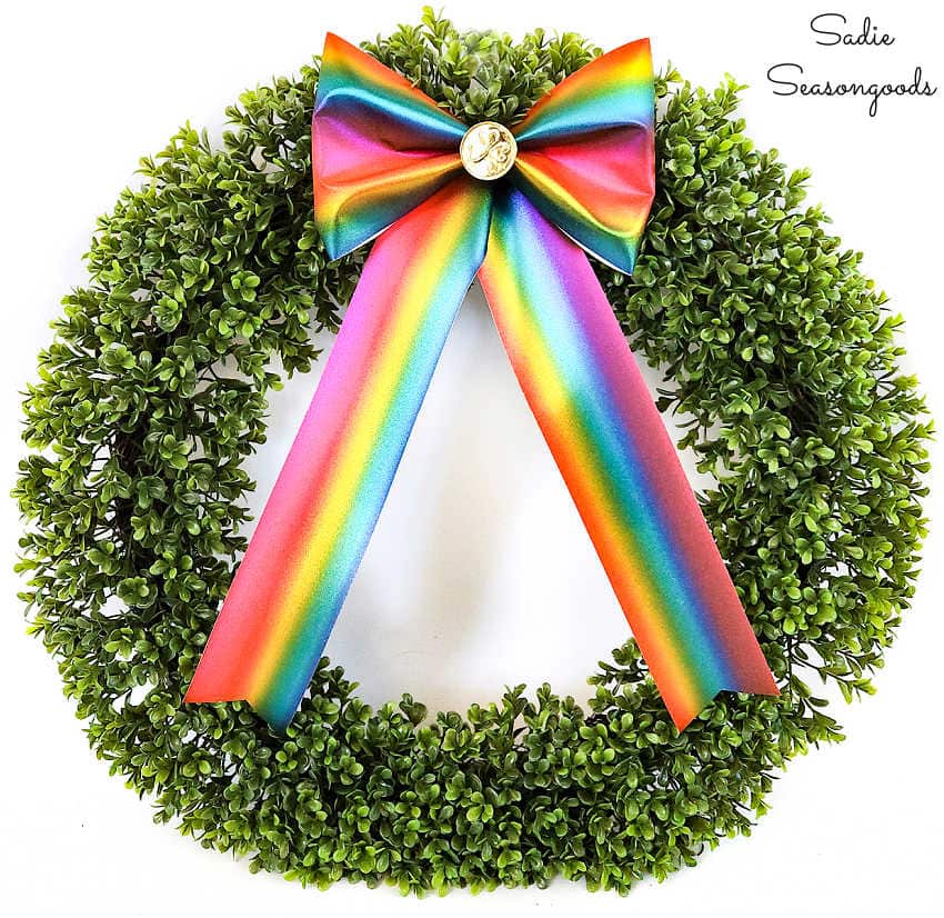 attaching a wreath bow to a boxwood wreath