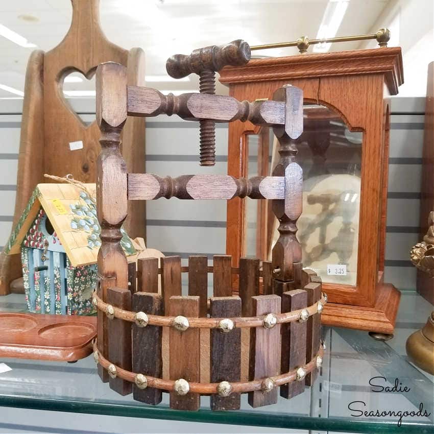 wooden nut cracker that looks like a water well