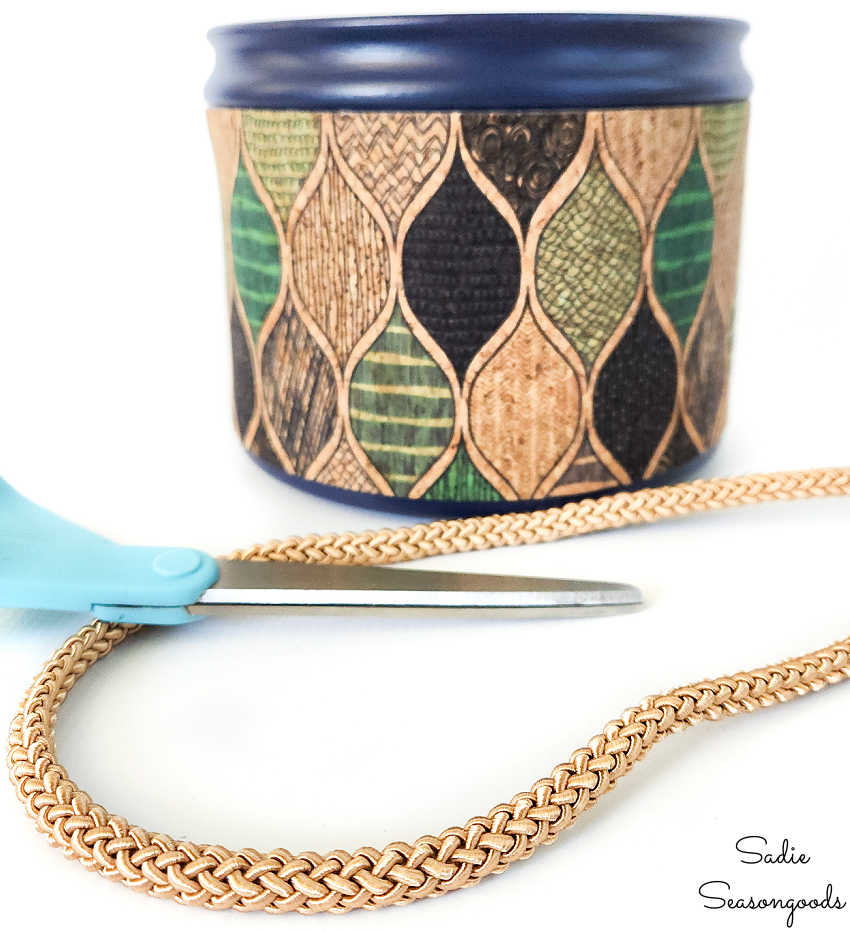 putting some gold cord on a coffee canister planter