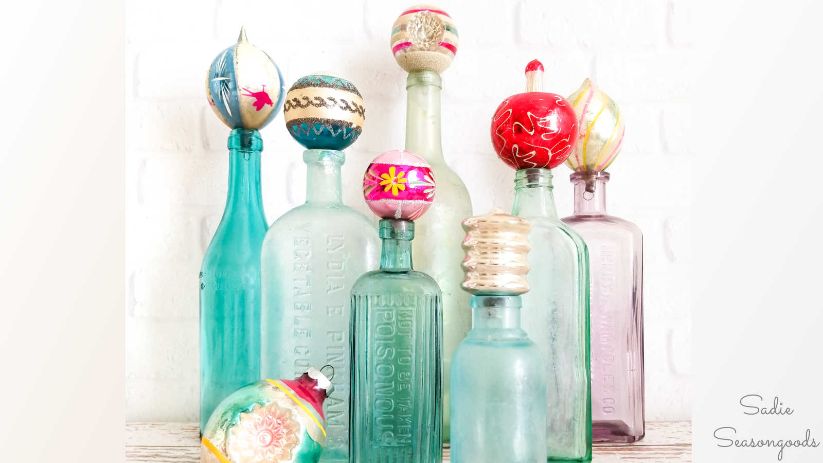 vintage bottles with christmas ornaments