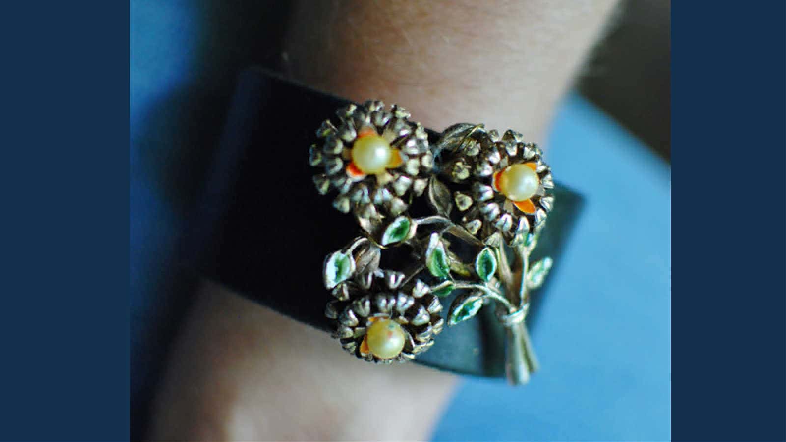 vintage jewelry on a leather cuff