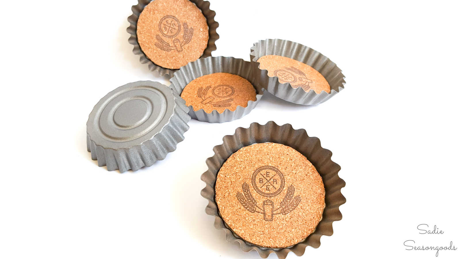cork coasters inside tart tins to look like beer bottle caps